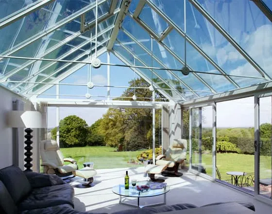 Glass conservatory with sloped roof