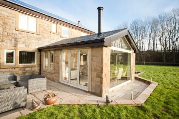 Modern conservatory with solid roof and chimney